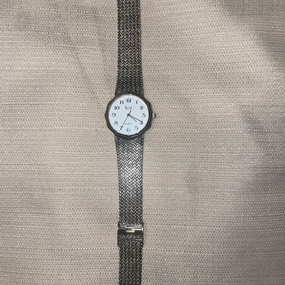 Koji watch silver tone stainless steel. Adjustable band.